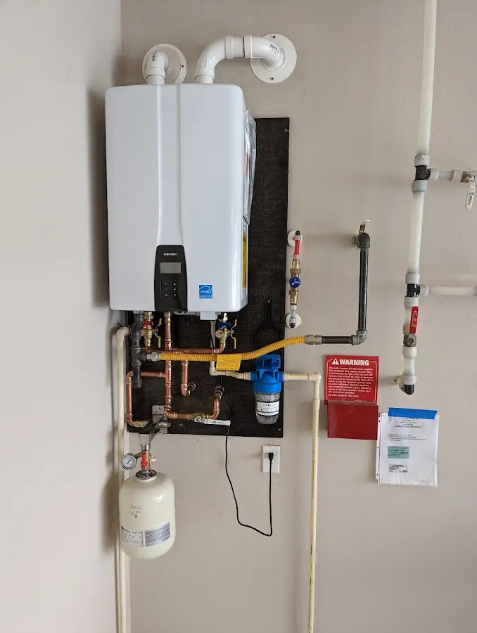 Professional plumber installing copper piping in a Mosinee home
